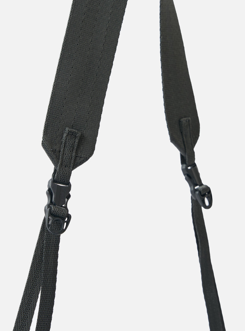 Close-up of the grey woven straps and black plastic buckles of the F/CE.® Grey 420 re/cor Sacoche against a plain white backdrop.
