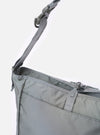 The F/CE.® Foliage Green Recycled Nylon 420 re/cor Courier Shoulder Bag is shown from the back as a flat lay against a plain white background. The image highlights the adjustable messenger-style shoulder strap with its plastic buckle and the clean, rectangular silhouette of the foliage green recycled nylon body.