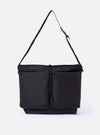 The F/CE. Black Recycled Nylon 420 re/cor Courier Shoulder Bag is shown as a flat lay against a plain white background. The messenger-style bag features a large front compartment with two vertical zips, a main zip closure, and an adjustable shoulder strap with a one-touch buckle mechanism. The black recycled nylon fabric has a subtle twill texture and a slight sheen.