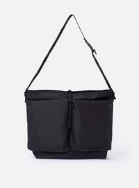 The F/CE. Black Recycled Nylon 420 re/cor Courier Shoulder Bag is shown as a flat lay against a plain white background. The messenger-style bag features a large front compartment with two vertical zips, a main zip closure, and an adjustable shoulder strap with a one-touch buckle mechanism. The black recycled nylon fabric has a subtle twill texture and a slight sheen.