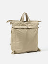 F/CE.® Sage Green Recycled Twill 3-Way Helmet Bag on a white background. The bag is a light green/tan color and made of a smooth, durable twill material. 