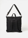 The F/CE.® Black Recycled Twill 3-Way Helmet Bag on a white background. The black bag has a shoulder strap and backpack straps.