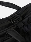 Close-up of the F/CE.® Black Recycled Twill 3-Way Helmet Bag. Shows black recycled twill material, straps, and buckles against a white backdrop. 