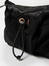 Close-up of the F/CE.® Black Nylon Cordura Sil Sacoche on a white surface. The bag features black nylon and cordura materials with a drawstring closure. 