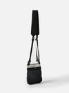The F/CE.® White Nylon Cordura Sil Portrait bag. The black bag has a white nylon top and hangs from a black strap. Shot against a white backdrop.