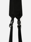 Close-up of the black nylon straps and plastic buckles of the F/CE.® White Nylon Cordura Sil Portrait bag against a white backdrop. The straps are textured and durable.
