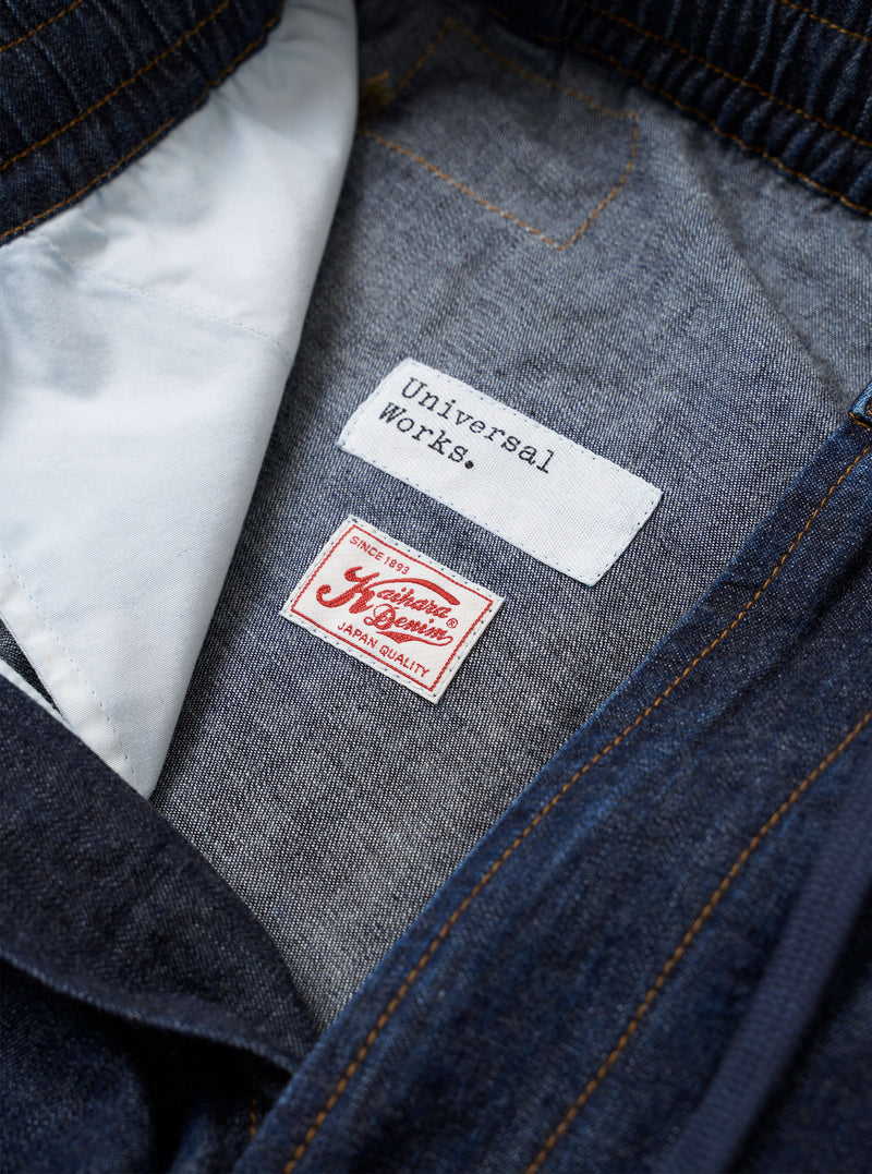 The Indigo Kaihara LT WT Denim Hi Water Trouser is shown as a flat lay against a plain white background. The trousers feature an elasticated waistband with a drawstring, a relaxed fit through the leg, and a cropped hem. The garment is made from a lightweight indigo blue denim fabric with visible seam detailing.