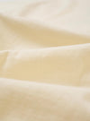 A close-up fabric swatch of the Kappy Cream Sundance Lounge Half Tee is shown, highlighting the soft, cream-colored cotton jersey material and its subtle knit texture. The fabric fills the entire frame.