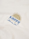 The Kappy White Sunny Wink Half Tee is shown from the back as a flat lay against a plain white background. The image highlights the clean, simple construction of the white cotton jersey fabric, featuring short sleeves and a straight hem.