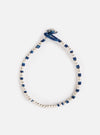 The Mikia Indigo Silver Beads Bracelet on a white background. The bracelet features silver beads and indigo-dyed string.