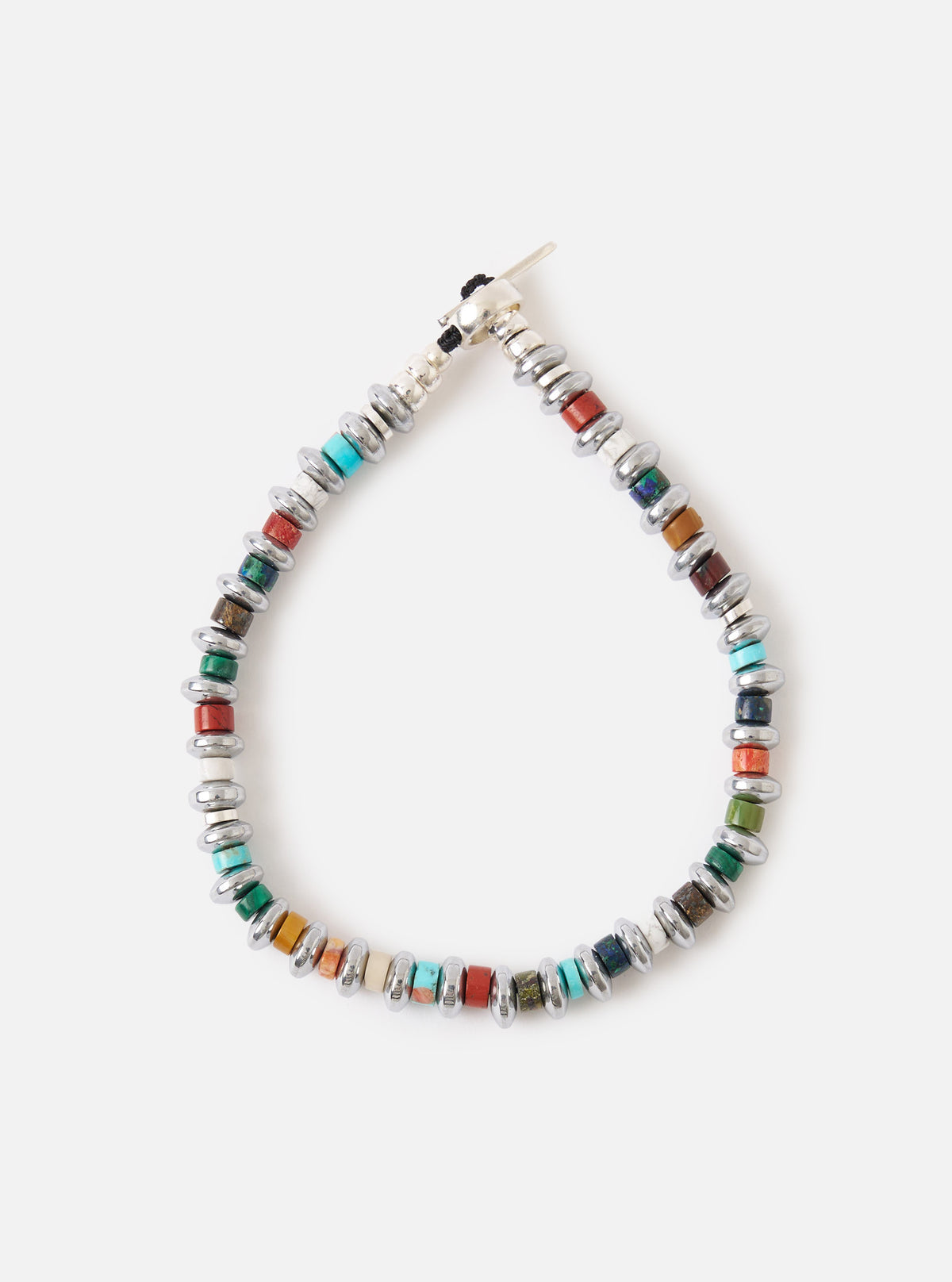 Close-up of the Mikia Multi Hematite Roundel Bracelet on a white surface. The bracelet features colorful stone beads and silver hematite roundels.