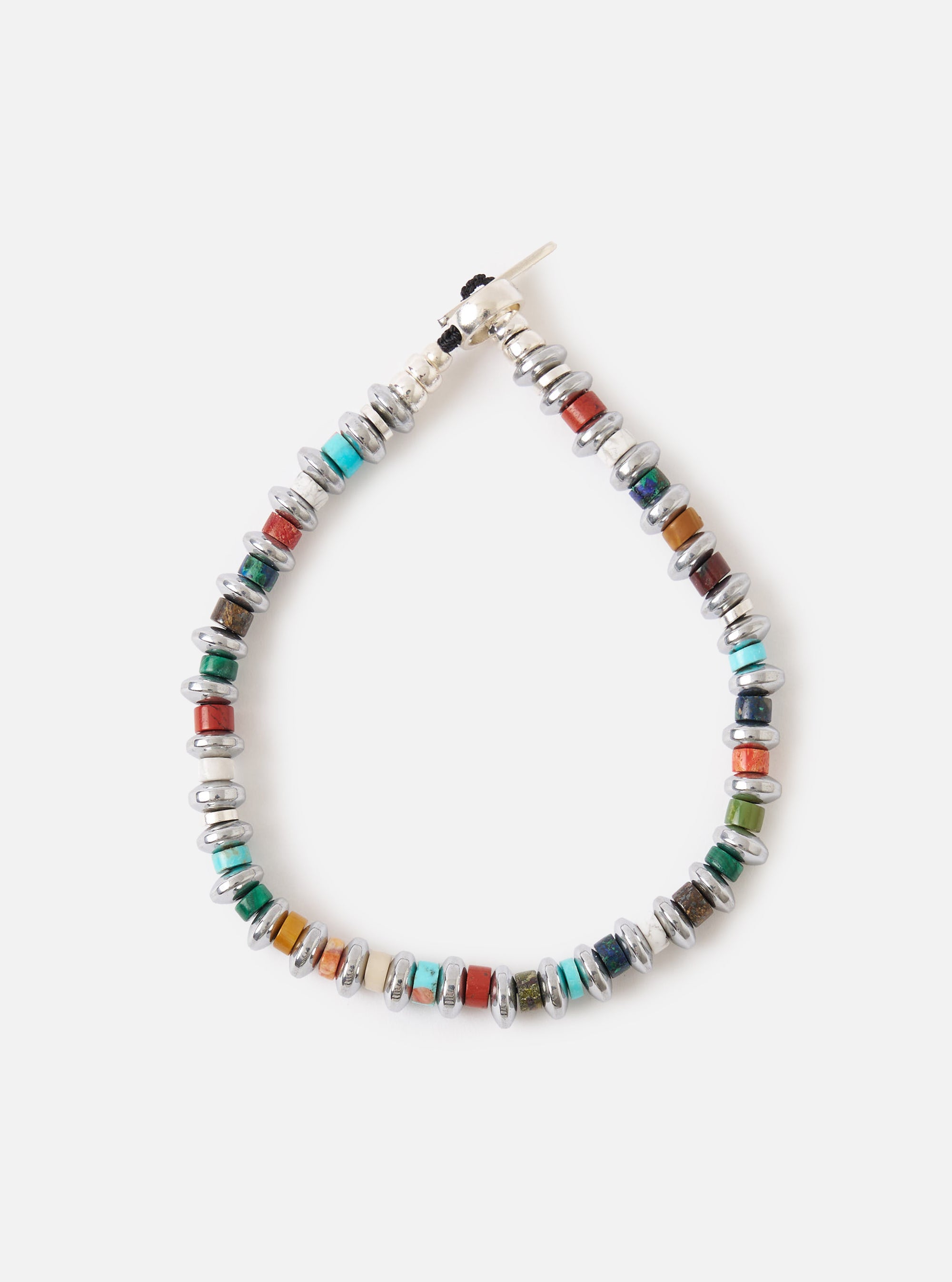 Close-up of the Mikia Multi Hematite Roundel Bracelet on a white surface. The bracelet features colorful stone beads and silver hematite roundels.