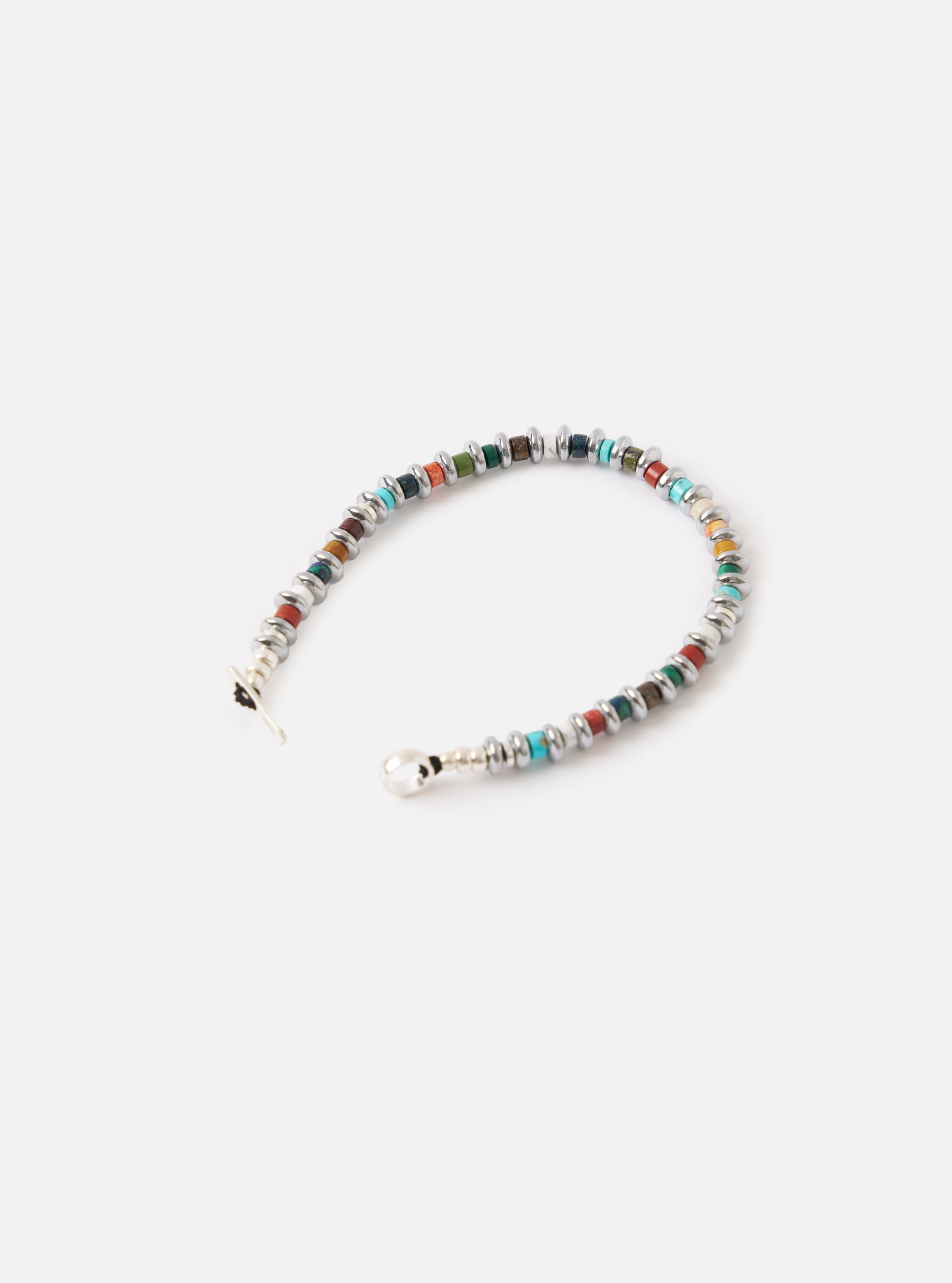 The Mikia Multi Hematite Roundel Bracelet on a white surface. The bracelet features colorful roundel beads separated by silver hematite rings.
