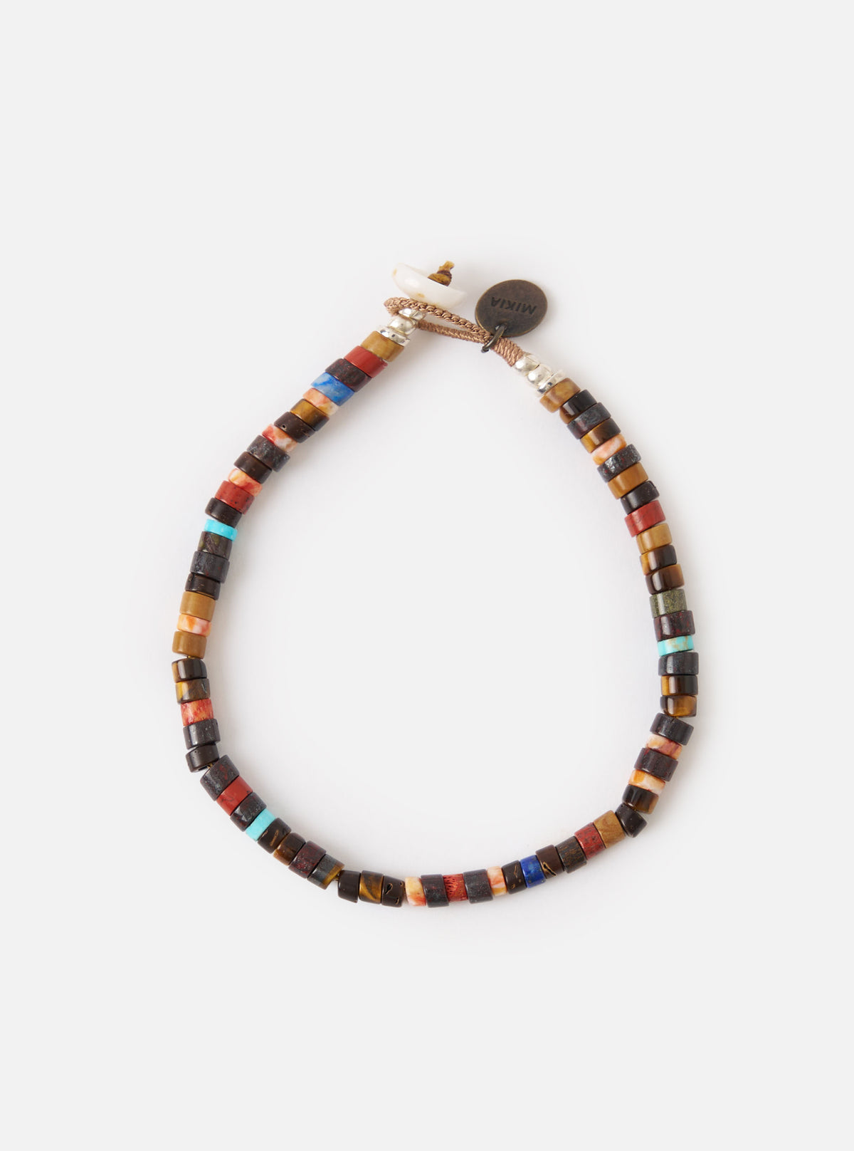 The Mikia Brown Multi Heishi Beads Bracelet on a white surface. The bracelet features brown, red, and blue beads. The bracelet is adjustable.
