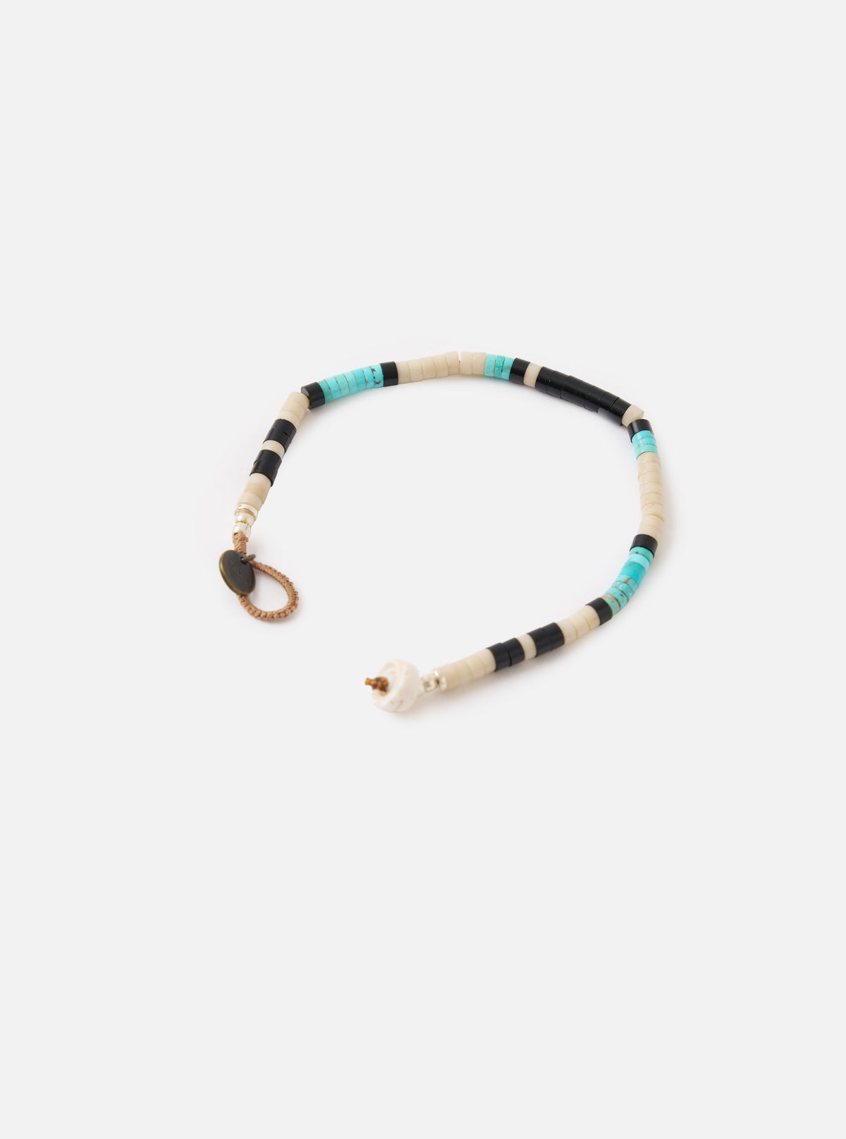 Mikia Fossil Jasper/Turquoise Heishi Beads Bracelet on a white background. The bracelet features turquoise, black, and cream beads. The bracelet has a brown cord and a metal clasp.