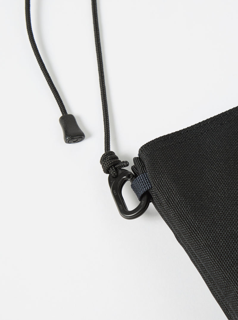 Close-up of the master-piece x Universal Works Black Recycled Tech Canvas Sacoche showing the black tech canvas material, black rope strap, and metal hardware on a white background.