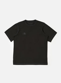 The master-piece x Universal Works Black Single Jersey Print Tee is shown as a flat lay against a white background. The short-sleeve t-shirt features a ribbed crew neckline and a white graphic print on the left chest.