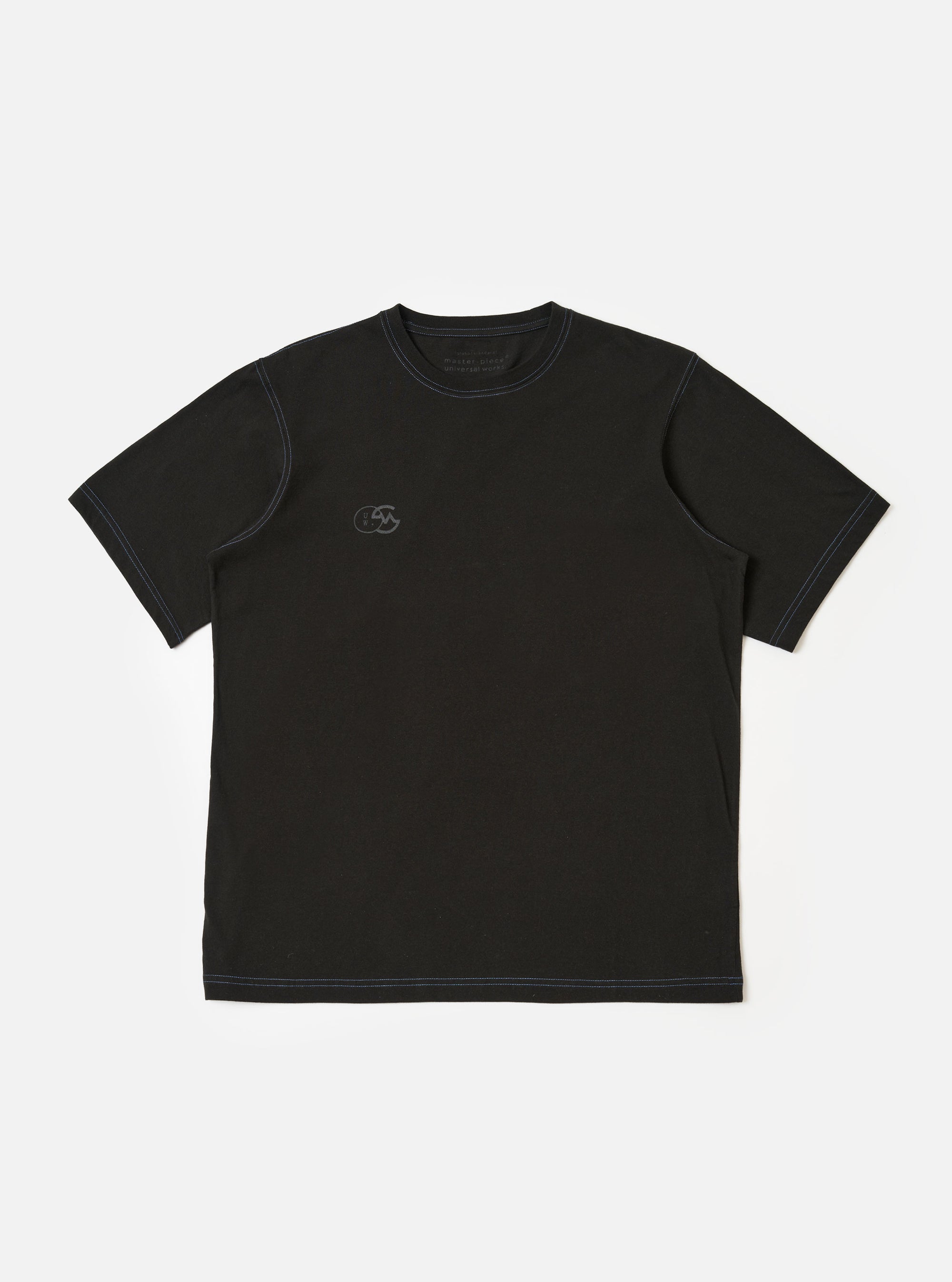 The master-piece x Universal Works Black Single Jersey Print Tee is shown as a flat lay against a white background. The short-sleeve t-shirt features a ribbed crew neckline and a white graphic print on the left chest.