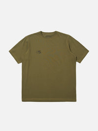 The master-piece x Universal Works Olive Single Jersey Print Tee is shown as a flat lay against a white background. The olive green short-sleeved t-shirt features a small graphic print on the left chest and a larger matching graphic print on the back. The garment has a ribbed crew neck and a straight hem.