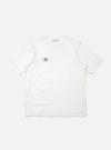 The master-piece x Universal Works White Single Jersey Print Tee is shown as a flat lay against a plain white background. This short-sleeved white t-shirt features a simple ribbed crew neckline and a relaxed fit. A small, dark graphic is printed on the left chest area, and a logo patch is visible near the front hem.