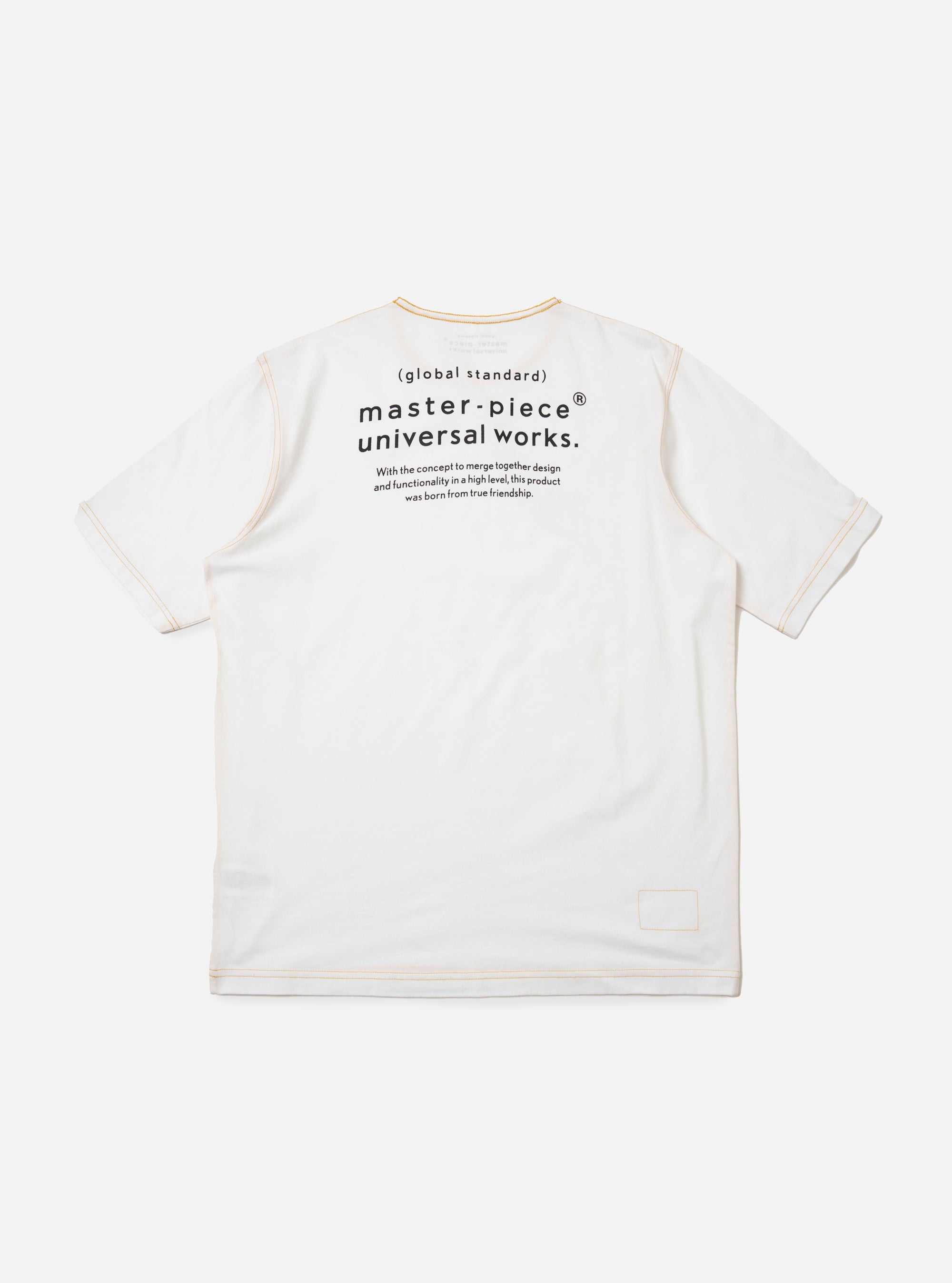 The master-piece x Universal Works White Single Jersey Print Tee is shown as a flat lay against a white background. The back of the white T-shirt is prominent, featuring a large graphic print and a horizontal storm flap across the upper back yoke.