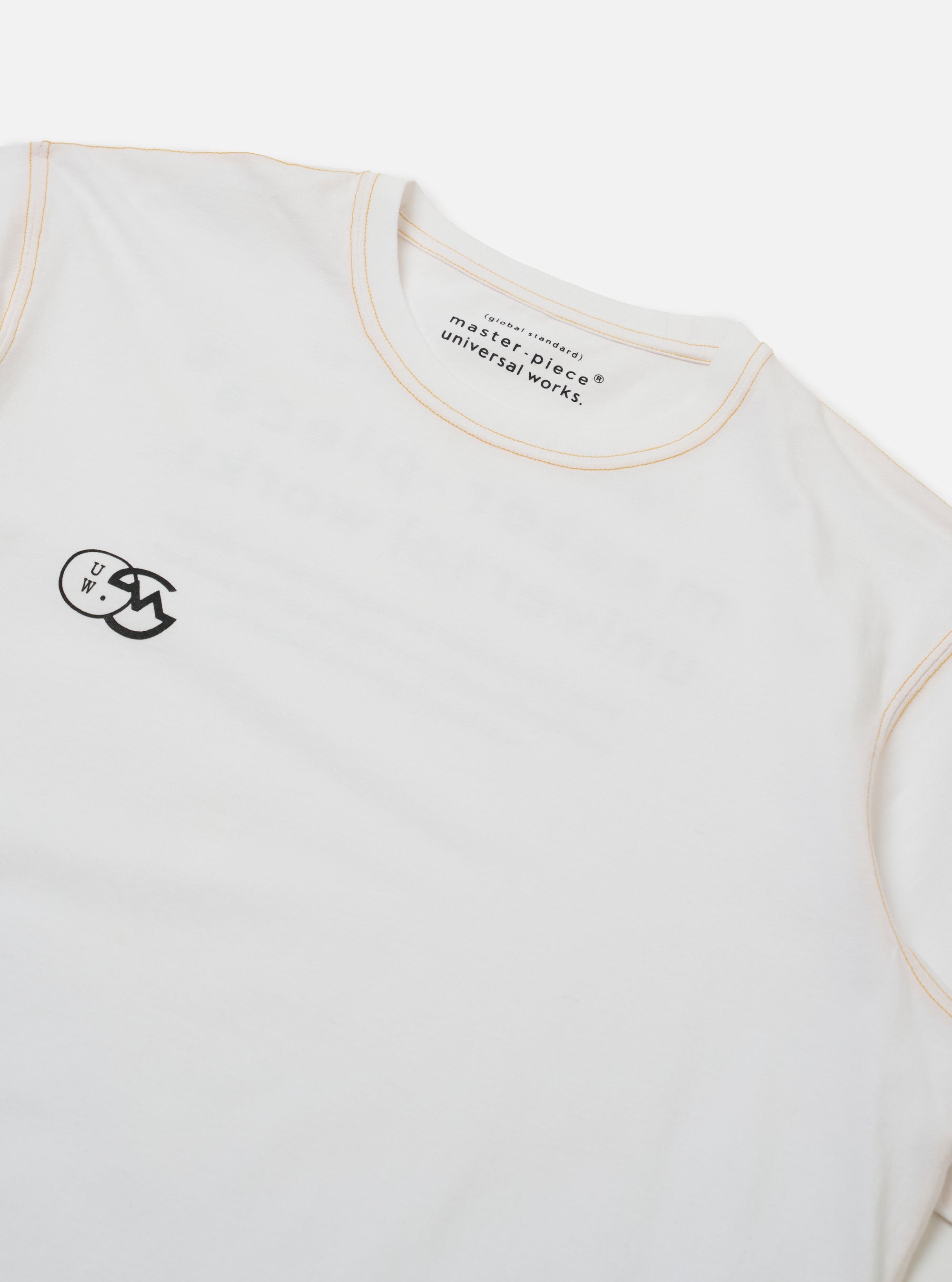 The master-piece x Universal Works White Single Jersey Print Tee is shown from the back as a flat lay against a plain white background. The shirt features a large, central graphic print on the reverse side. The garment has short sleeves and a ribbed crew neck.