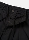 The master-piece x Universal Works Black Recycled Poly Tech Pleated Track Short is shown from the back as a flat lay against a plain white background. The image highlights the elasticated waistband with a drawstring, two rear welt pockets, and the loose fit of the shorts.
