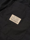 The master-piece x Universal Works Black Recycled Poly Tech Pleated Track Short is shown from a rear angle as a flat lay against a white background. The image highlights the two rear pockets, the elasticated waistband with belt loops, and the loose, relaxed fit of the black fabric.