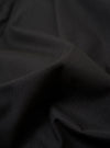 The master-piece x Universal Works Black Recycled Poly Tech Pleated Track Short is shown from the back as a flat lay against a plain white background. The image highlights the two rear pockets, the elasticated waistband with belt loops, and the loose, relaxed fit of the black fabric.