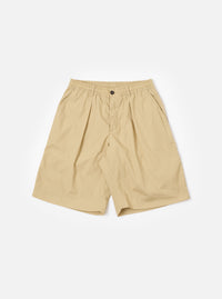 The master-piece x Universal Works Sand Recycled Poly Tech Pleated Track Short is shown as a flat lay against a plain white background. The shorts feature a relaxed, loose fit with a prominent single pleat on each leg, an elasticated waistband with a matching drawstring, and a zip fly. Two side pockets are visible. The fabric is a compact, sand-colored recycled polyester and cotton blend.