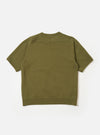 The master-piece x Universal Works Olive Brush Back Sweat S/S Billy Sweat is shown from the back as a flat lay against a plain white background. The short-sleeve sweatshirt features a ribbed collar and a small brand patch near the bottom hem.