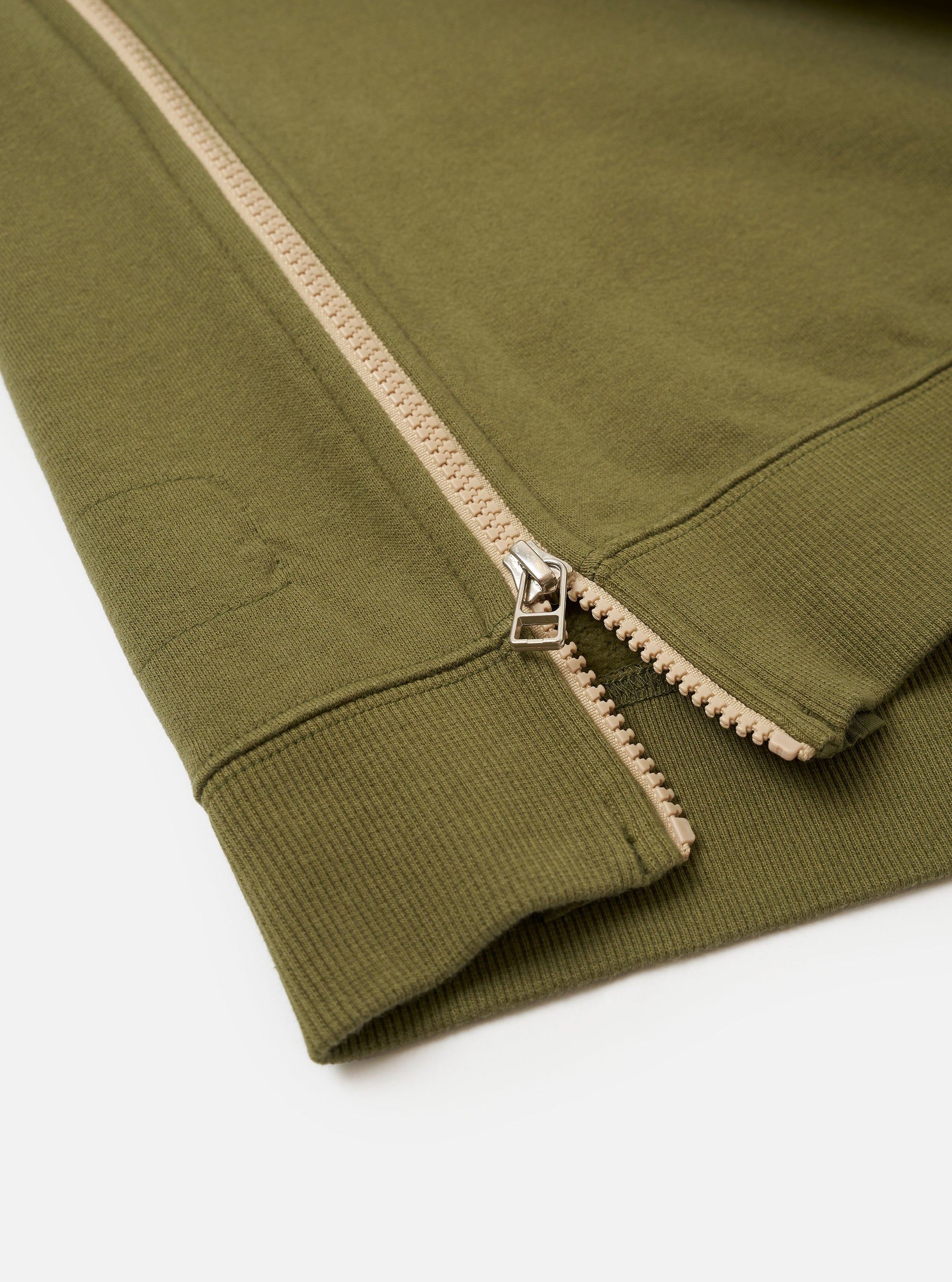 The master-piece x Universal Works Olive Brush Back Sweat S/S Billy Sweat is shown from the back as a flat lay against a plain white background. The short-sleeved sweatshirt features a ribbed crew neck, a straight hem, and a small collaborative brand patch near the bottom left side.