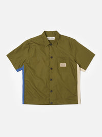 The master-piece x Universal Works Olive Recycled Poly Tech Tech Overshirt is shown as a flat lay against a plain white background. The short-sleeve overshirt features a one-piece collar, a central button-through closure, and a single reinforced patch pocket on the left chest. The olive green recycled polytech fabric has a clean, smooth appearance.