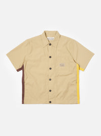 The master-piece x Universal Works Sand Recycled Poly Tech Tech Overshirt is shown as a flat lay against a plain white background. The short-sleeve overshirt features a one-piece collar, a central button-down closure, and a single reinforced patch pocket on the left chest. The sand-colored recycled polytech fabric has a smooth, technical finish.