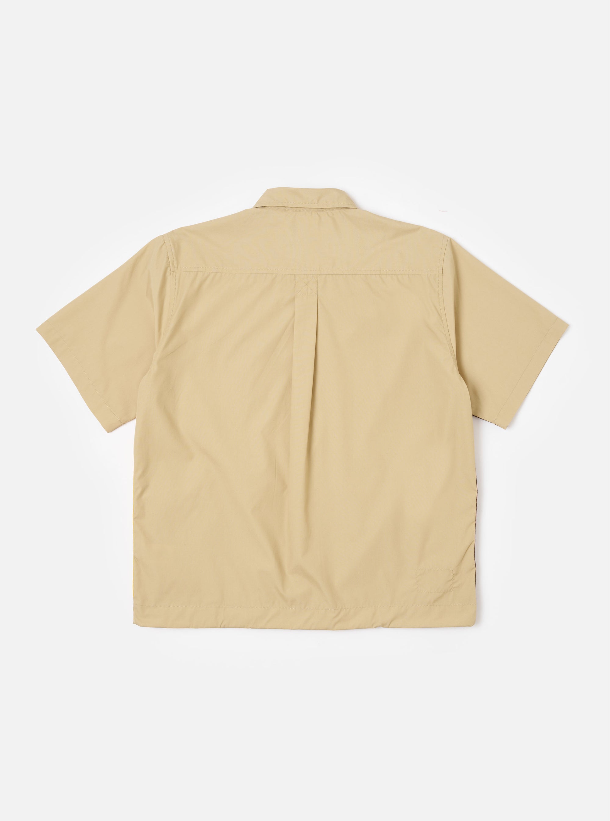 The master-piece x Universal Works Sand Recycled Poly Tech Tech Overshirt is shown from the back as a flat lay against a plain white background. The image highlights the clean lines of the sand-colored technical fabric, a straight hem, and a back yoke with a central box pleat for added movement.