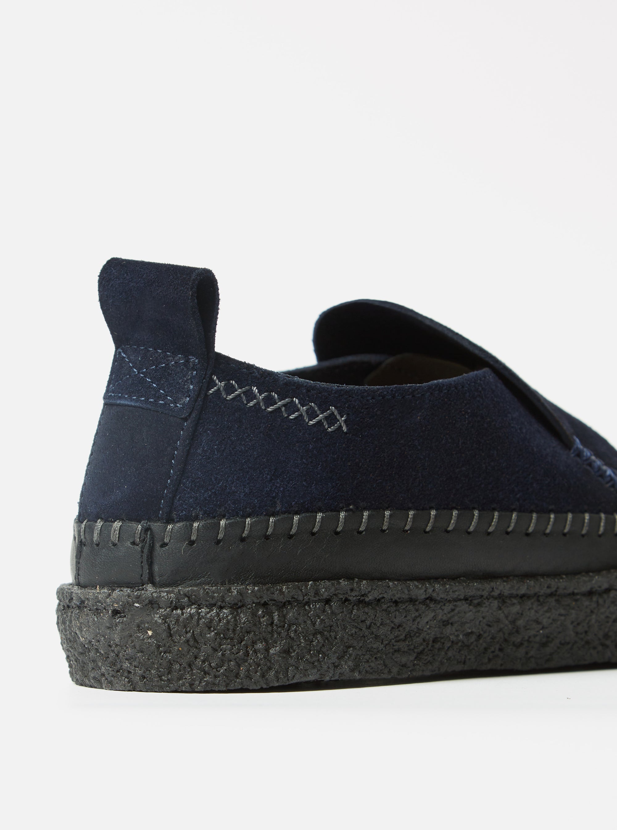 Close-up of the Yogi x Universal Works Hitch Loafer in Indigo Suede/Crepe. Features indigo suede upper, black leather trim, and a black crepe sole. Shot on a white background.