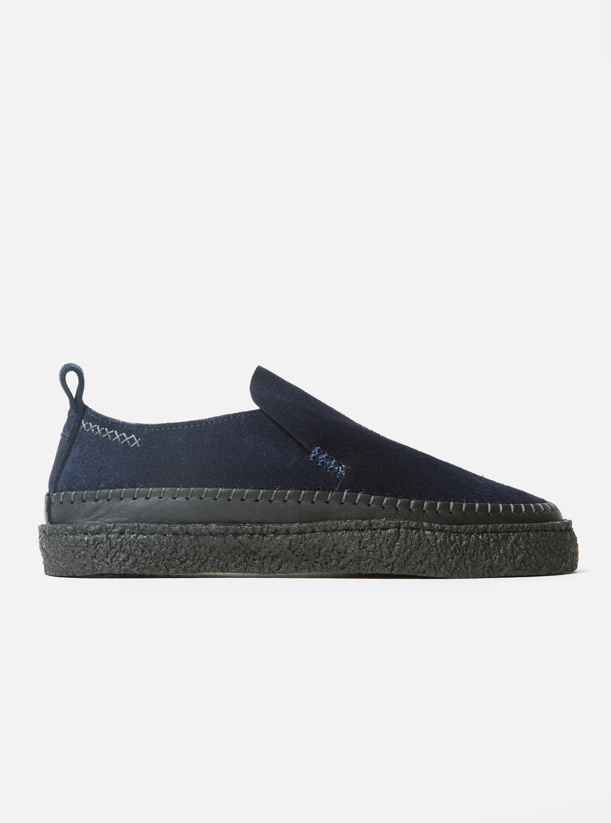 Side view of the Yogi x Universal Works Hitch Loafer in Indigo Suede/Crepe on a white background. The shoe is indigo suede with a black crepe sole.