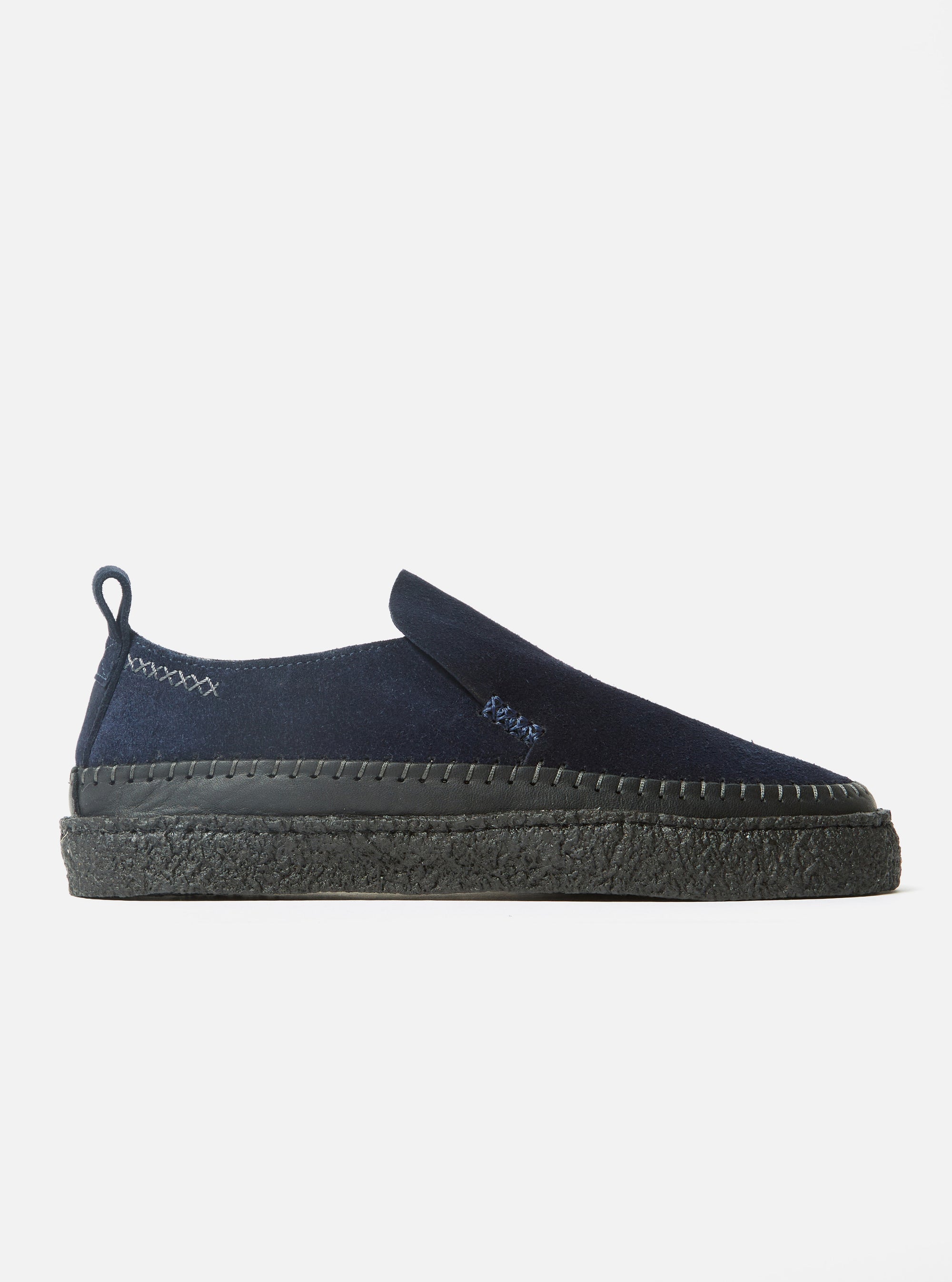 Side view of the Yogi x Universal Works Hitch Loafer in Indigo Suede/Crepe on a white background. The shoe is indigo suede with a black crepe sole.