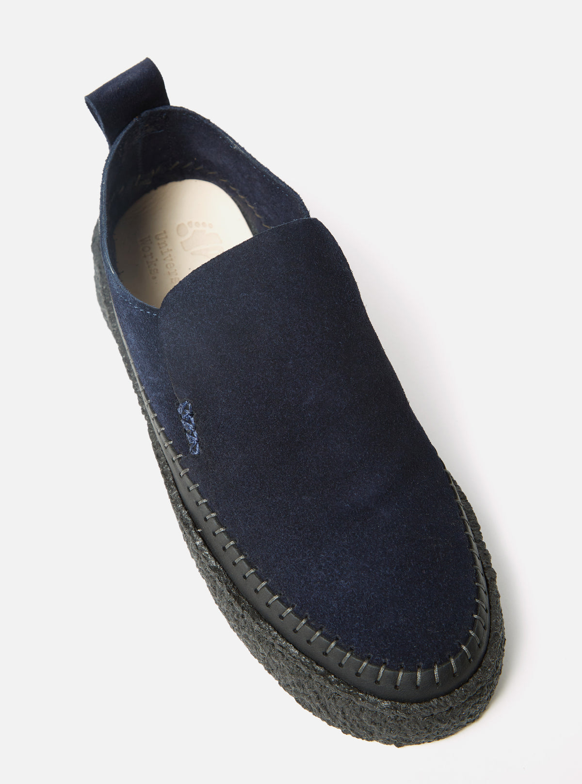 Close-up of the Yogi x Universal Works Hitch Loafer in Indigo Suede/Crepe. The shoe is indigo suede with a black crepe sole. Shot on a white background.