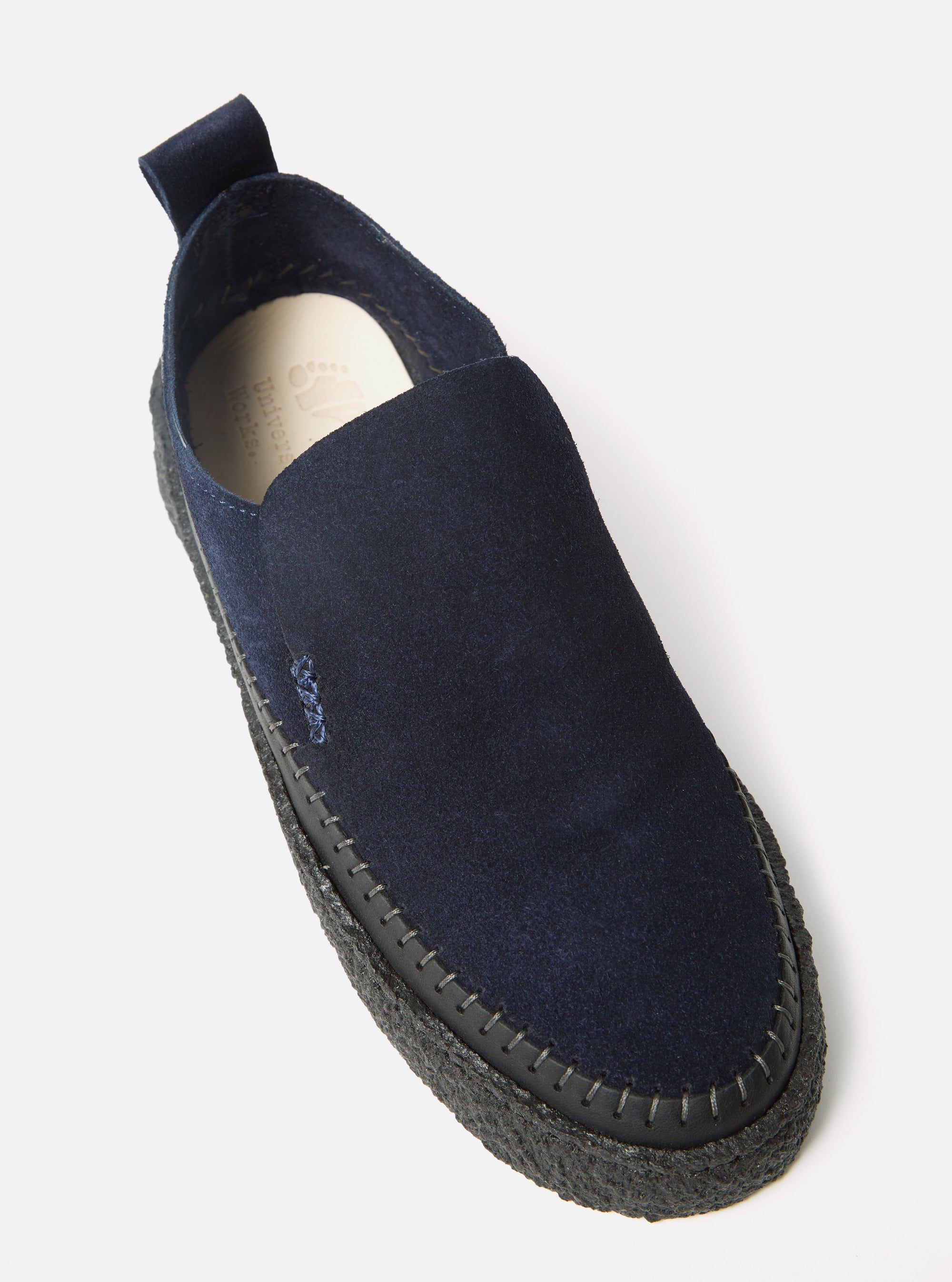 Close-up of the Yogi x Universal Works Hitch Loafer in Indigo Suede/Crepe. The shoe is indigo suede with a black crepe sole. Shot on a white background.