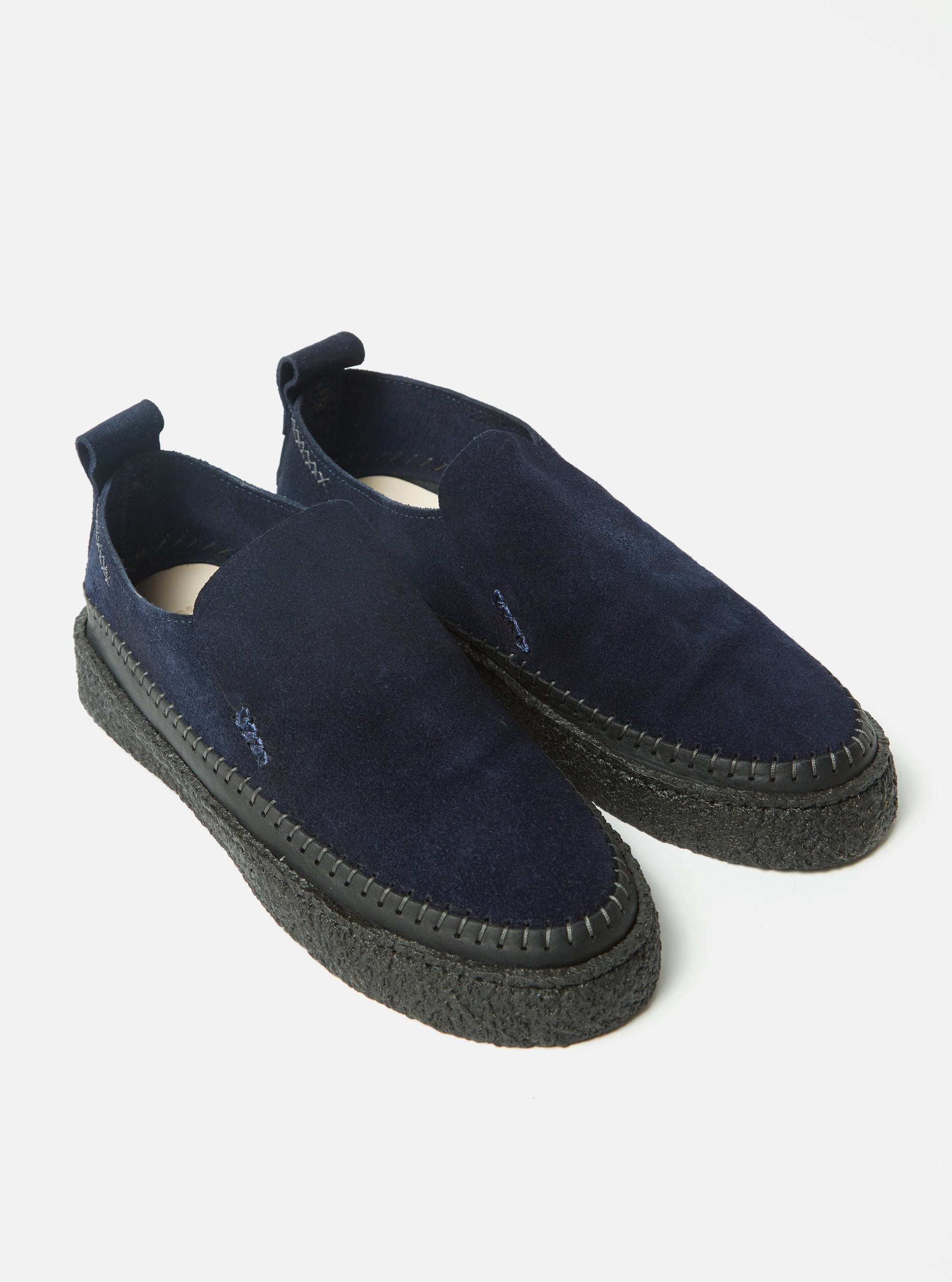 Studio shot of Yogi x Universal Works Hitch Loafer in Indigo Suede/Crepe. The indigo suede loafers feature a crepe sole and are set against a clean white background.