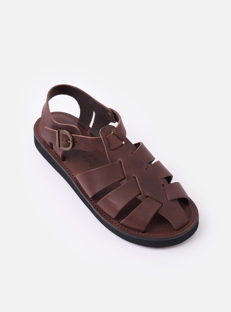 The Organic Handloom Dark Brown Leather Gurkha is shown from a rear three-quarter angle as a flat lay against a plain white background. The image highlights the closed heel counter, the adjustable ankle strap with a silver-tone metal buckle, and the dark brown leather construction. The foam rubber outsole is visible at the base of the shoe.