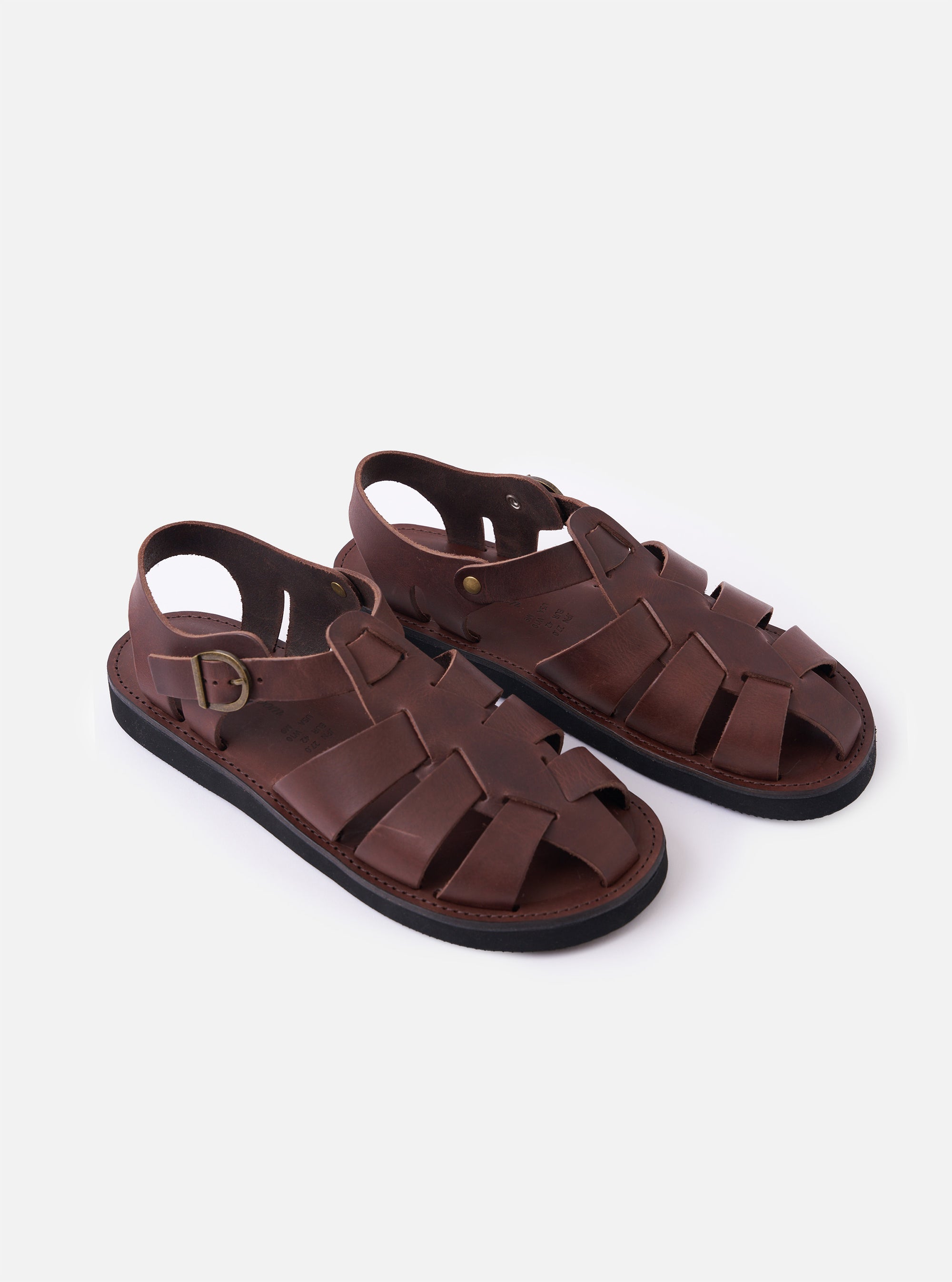 The Organic Handloom Dark Brown Leather Gurkha is shown from a rear angle as a flat lay against a plain white background. The image highlights the closed-back construction, the adjustable ankle strap with a silver-tone metal buckle, and the textured foam rubber outsole.