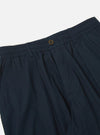 Close-up of the Navy Broadcloth Oxford Pant on a white background. Shows the elastic waistband, button closure, and broadcloth material.