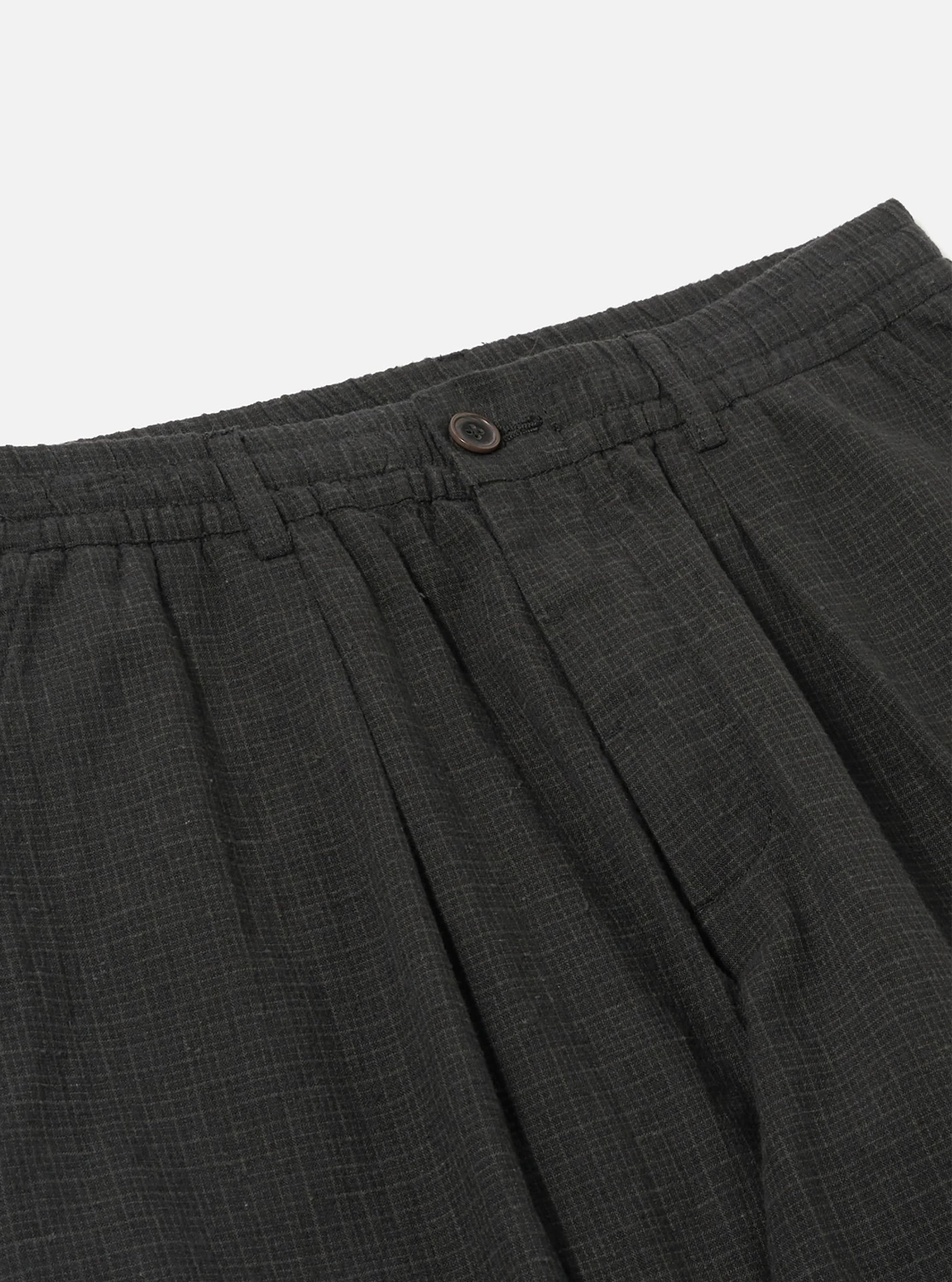 Close-up of the Charcoal Fine Linen Mix Pleated Track Pant on a white background, showing the waistband, button, and pleats.