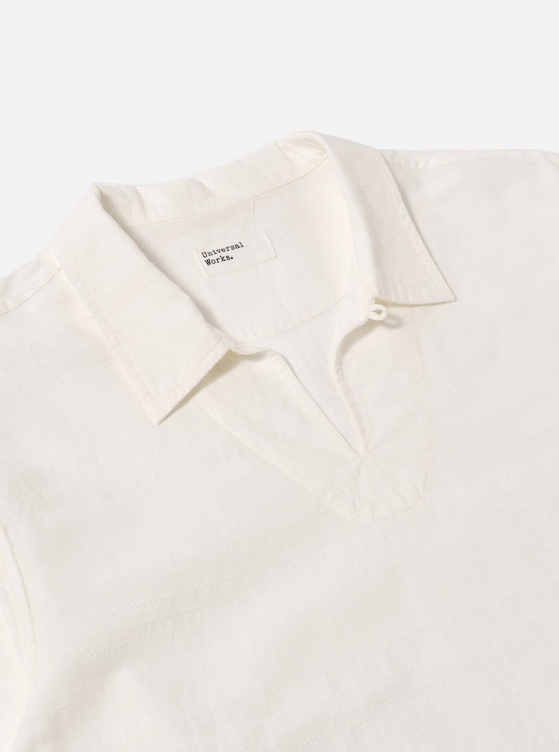 Close-up of the Ecru Deffe Self Stripe Smock Overshirt on a white background. The shirt is a light cream color with subtle stripes. The collar is open and the fabric is textured.