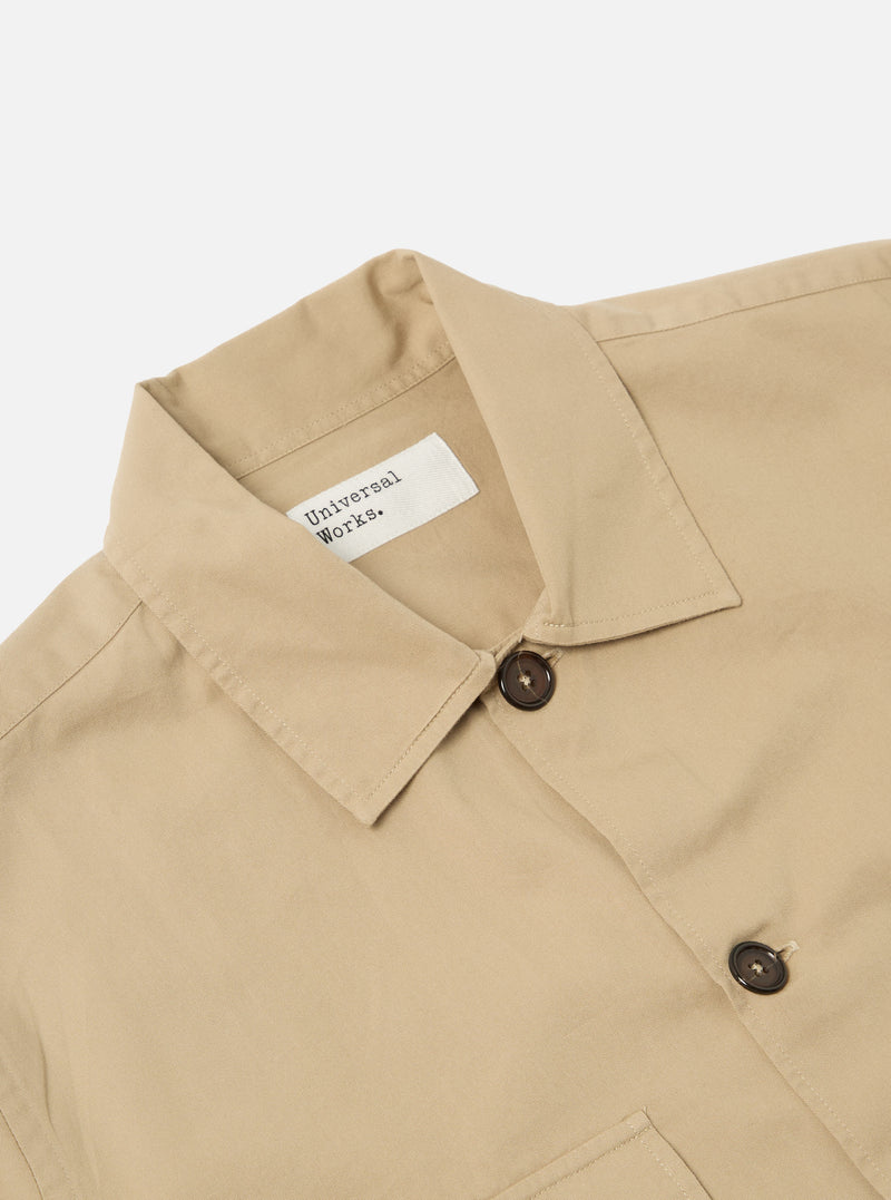 Close-up of the Sand Military Cotton Dockside Overshirt on a white background. The cotton overshirt has a classic collar and dark brown buttons.