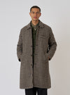 A model poses in a Sand Cortina Tweed Long Swing Coat. The coat is tweed with a sand and black pattern. The background is a plain white studio backdrop.