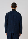 Back view of a model wearing the Black/Indigo Denim Camo Cabin Jacket. The jacket has a subtle camo pattern. Shot against a plain white background.