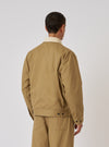 Back view of a model wearing the Khaki Works Twill Rose Bowl Jacket. The jacket is khaki twill with a cream collar. Shot against a white background.